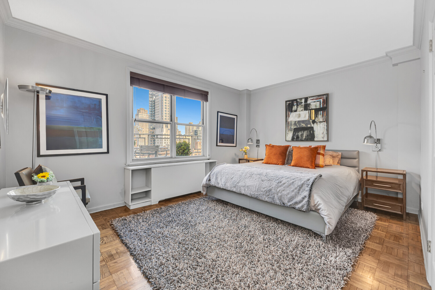207 East 74th Street, Unit PHG Manhattan, NY 10021 - Photo 7 of 12 a bedroom with a bed and dresser with wooden floor
