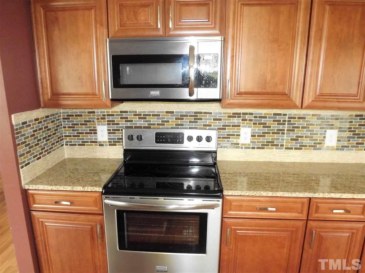 7032 Spanglers Spring Way Raleigh, NC 27610 - Photo 12 of 25 a stove top oven sitting inside of a kitchen