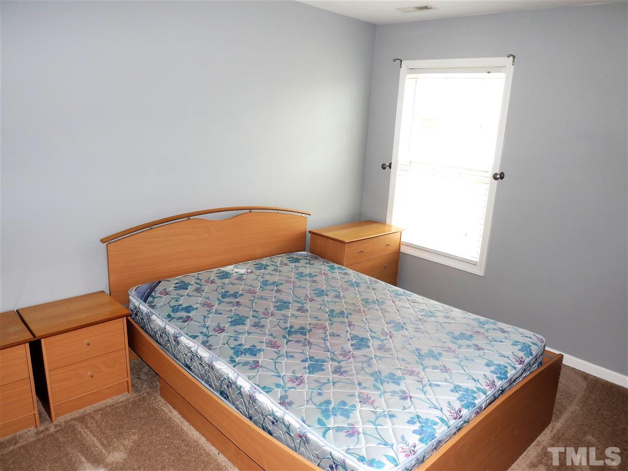 7032 Spanglers Spring Way Raleigh, NC 27610 - Photo 17 of 25 a bedroom with a bed and dresser