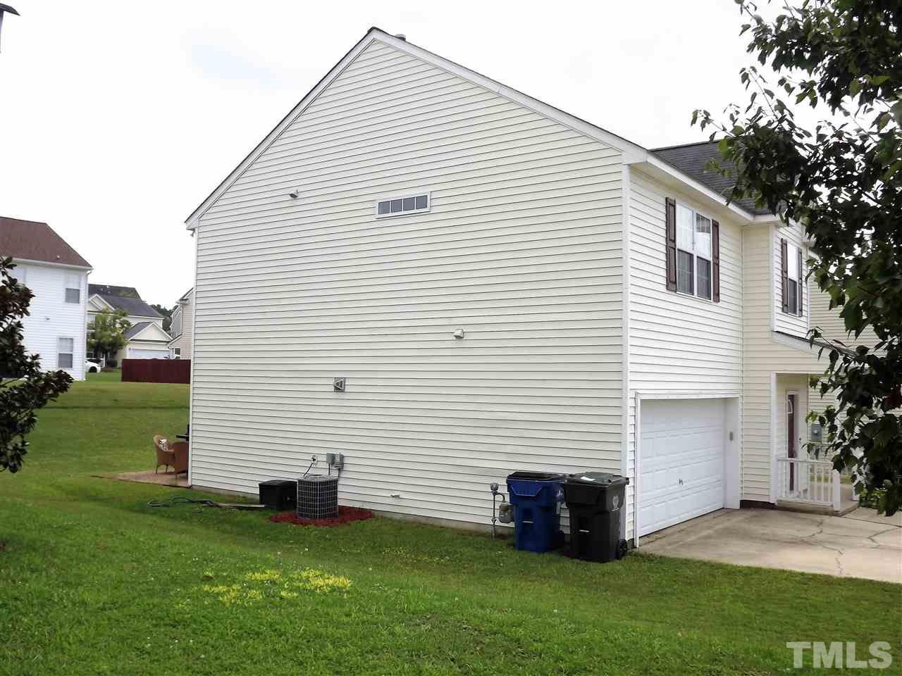 7032 Spanglers Spring Way Raleigh, NC 27610 - Photo 3 of 25 a view of a white house next to a yard