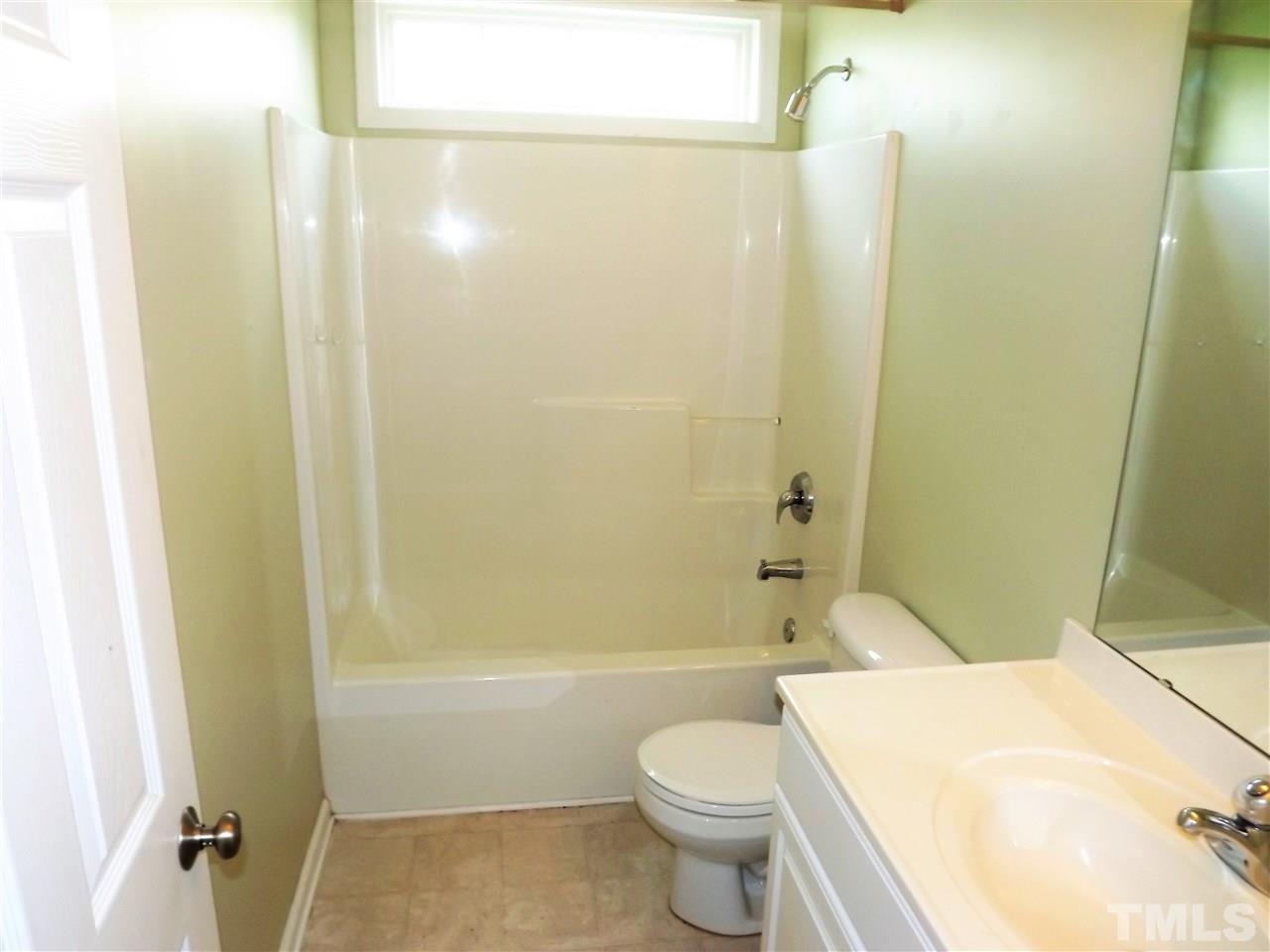 7032 Spanglers Spring Way Raleigh, NC 27610 - Photo 22 of 25 a bathroom with a toilet a sink and bathtub