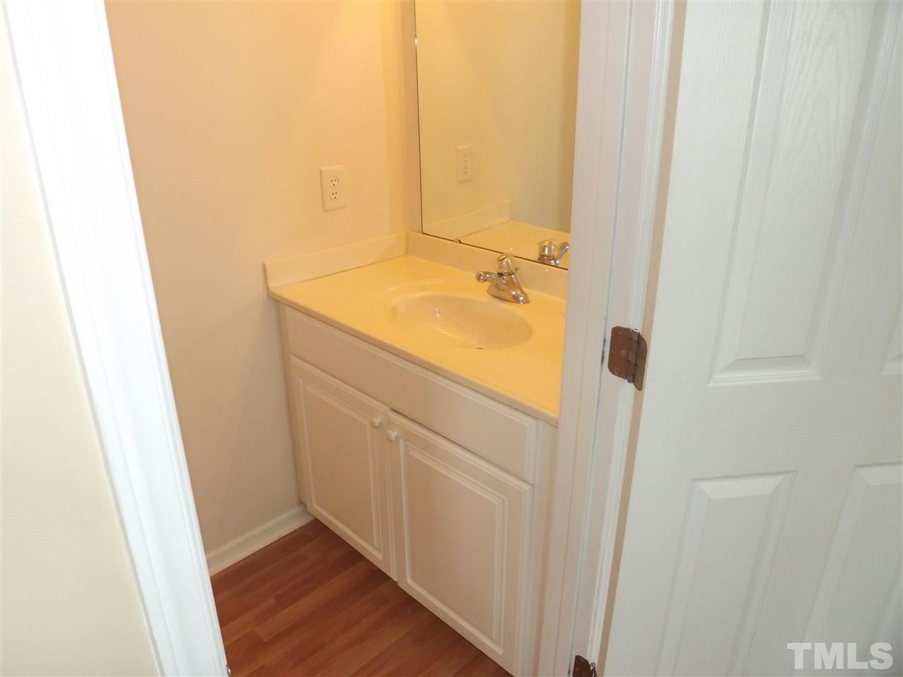 7032 Spanglers Spring Way Raleigh, NC 27610 - Photo 23 of 25 a bathroom with a sink and mirror