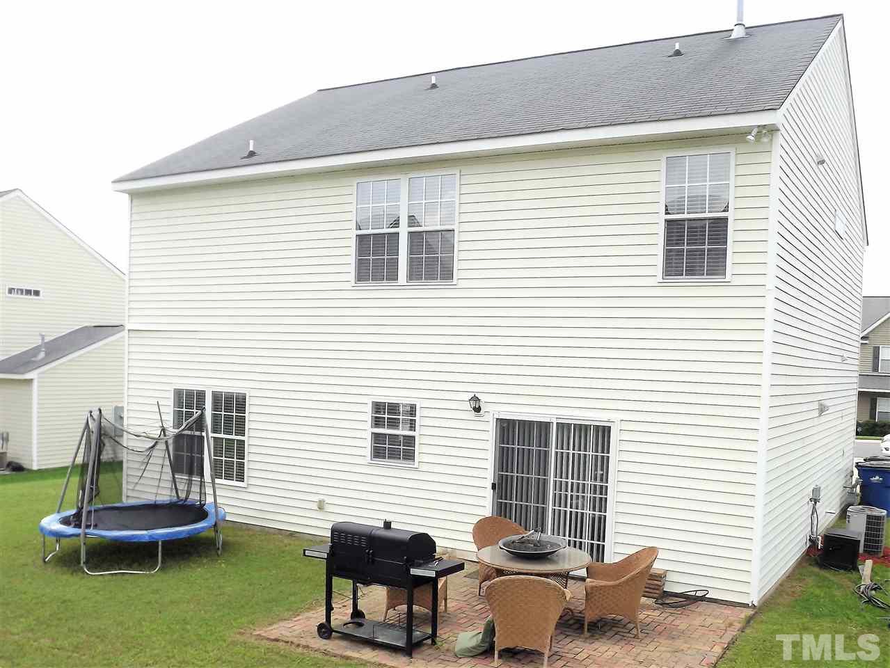 7032 Spanglers Spring Way Raleigh, NC 27610 - Photo 4 of 25 a view of a patio with a table and chairs and a barbeque