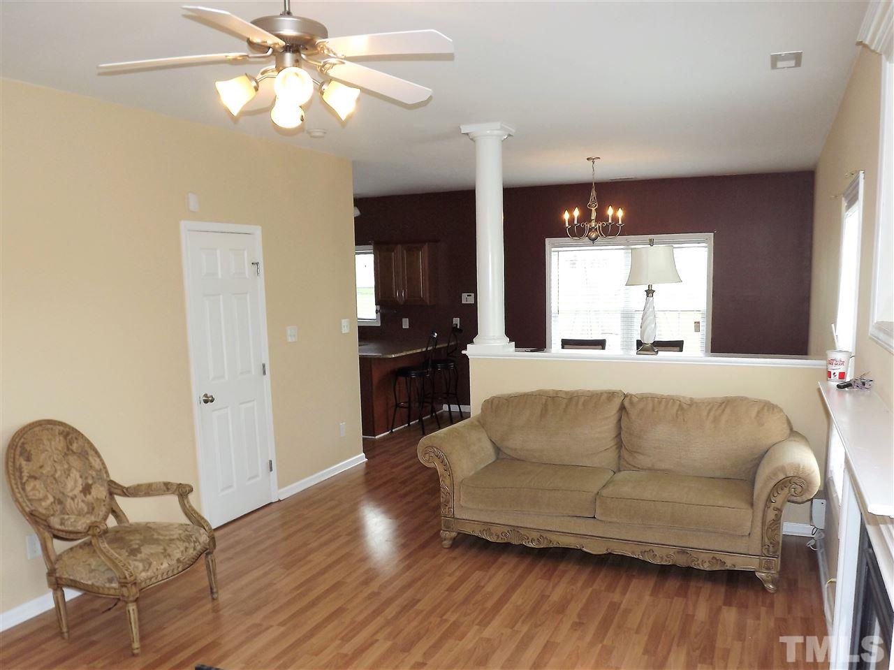 7032 Spanglers Spring Way Raleigh, NC 27610 - Photo 6 of 25 a living room with furniture and a wooden floor