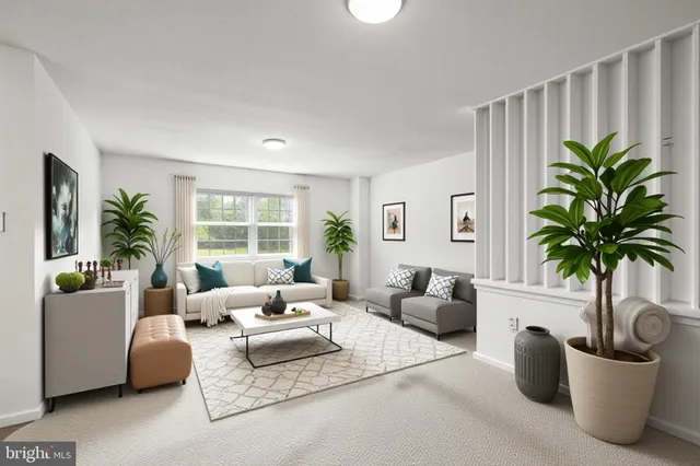 a living room with furniture and potted plant