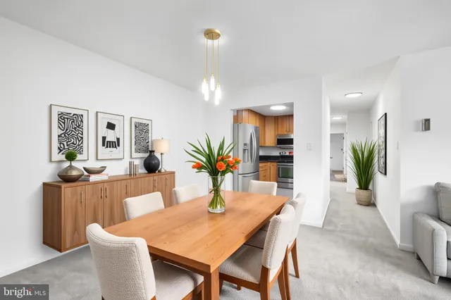 a dining room with furniture and wooden floor