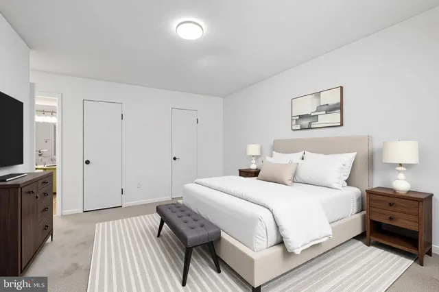 a large white bed in a white room