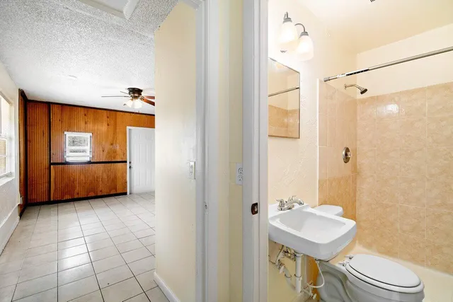 a bathroom with a sink a toilet and mirror