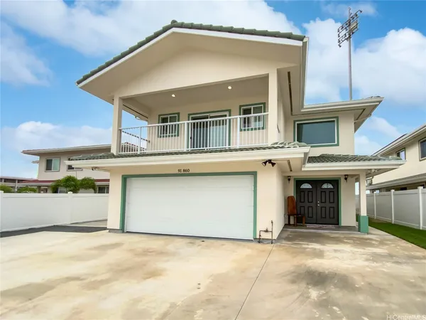 a front view of a house with a garage and a window