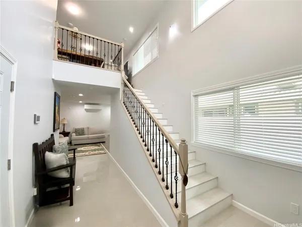 a view of entryway and hall with wooden floor