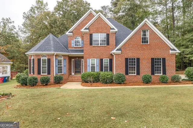 a front view of a house with a yard