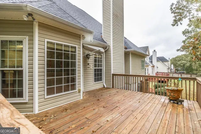 a view of a deck with wooden floor and fence