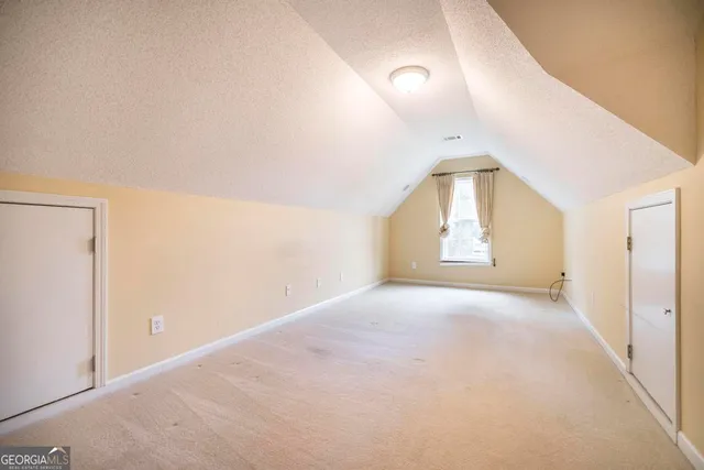 an empty room with a empty space and windows