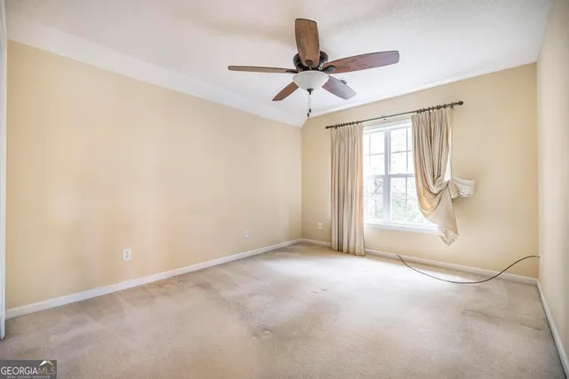 a view of room with window and ceiling fan