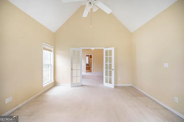 an empty room with windows and cabinet