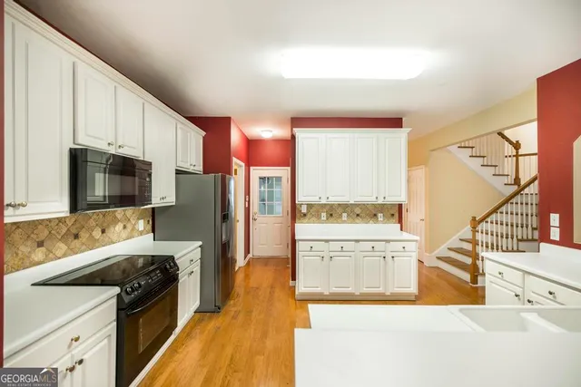 a view of a kitchen with a sink and a refrigerator