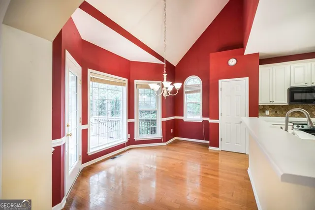 a view of an entryway with wooden floor