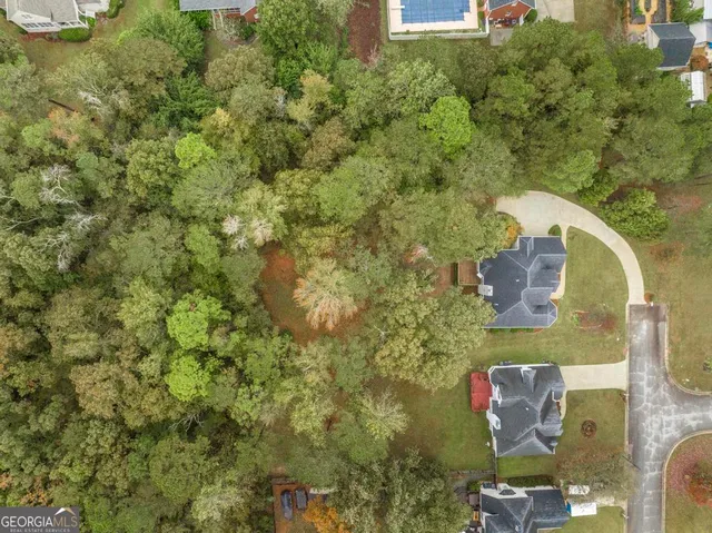 an aerial view of a house with a yard and garden view