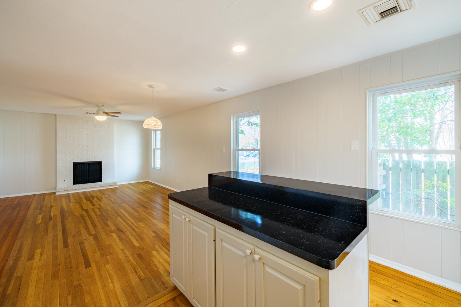 1400 Ruth Avenue Austin, TX 78757 - Photo 12 of 29 Warm hardwood flooring flows throughout the open living area anchored by a classic fireplace.