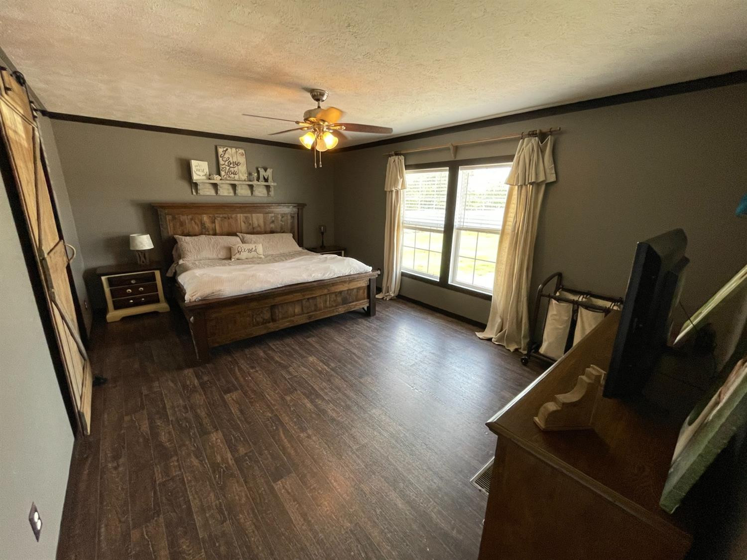 403 Geisler Quitaque, TX 79255 - Photo 16 of 26 a bedroom with furniture window and wooden floor