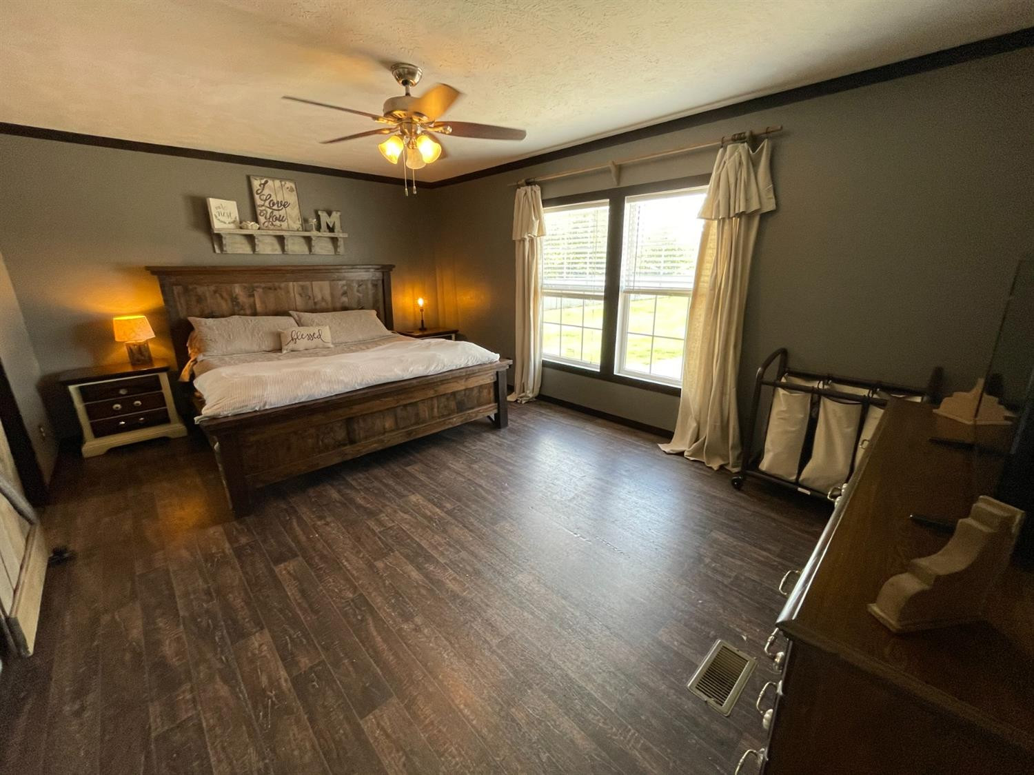 403 Geisler Quitaque, TX 79255 - Photo 19 of 26 a bedroom with a bed and wooden floor