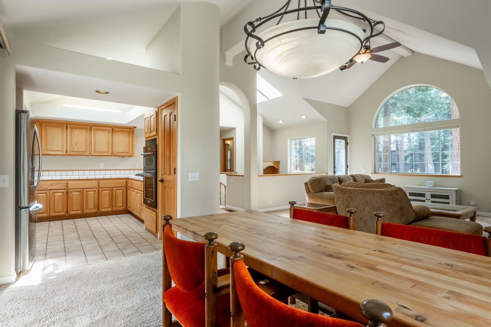272 Ridge Way Mammoth Lakes, CA 93546 - Photo 22 of 55 Vaulted ceilings with exposed beams and a large arched window characterize this spacious living area
