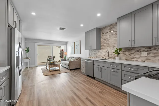 a large white kitchen with a large window