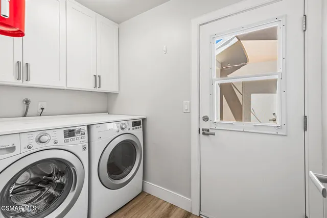 a view of a hallway with washer and dryer