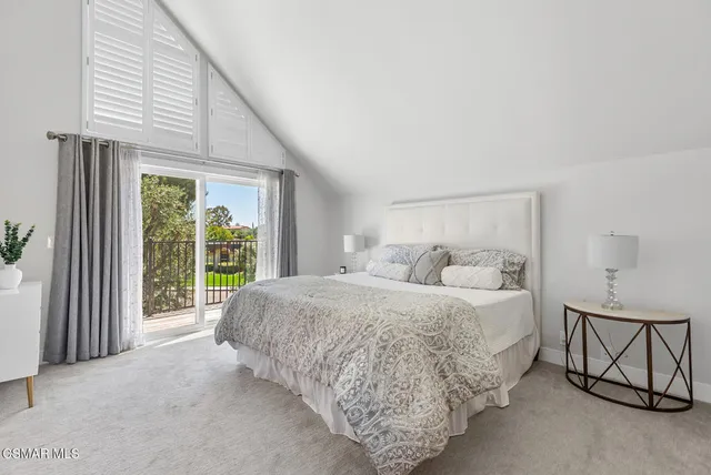 a bedroom with a large bed and a window