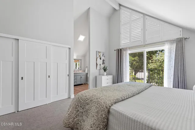 a bedroom with a bed and a couch