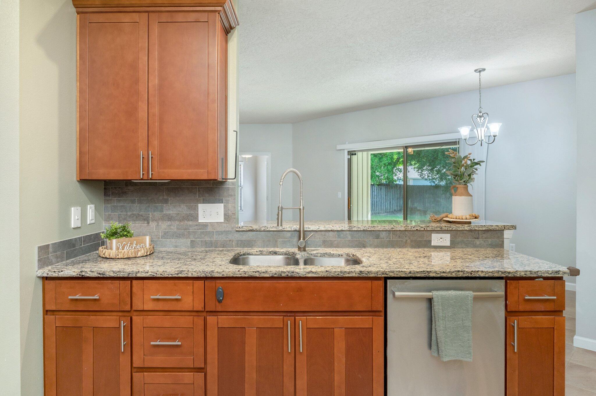 5280 Moore Loop Crestview, FL 32536 - Photo 18 of 54 a kitchen with granite countertop stainless steel appliances sink and cabinets