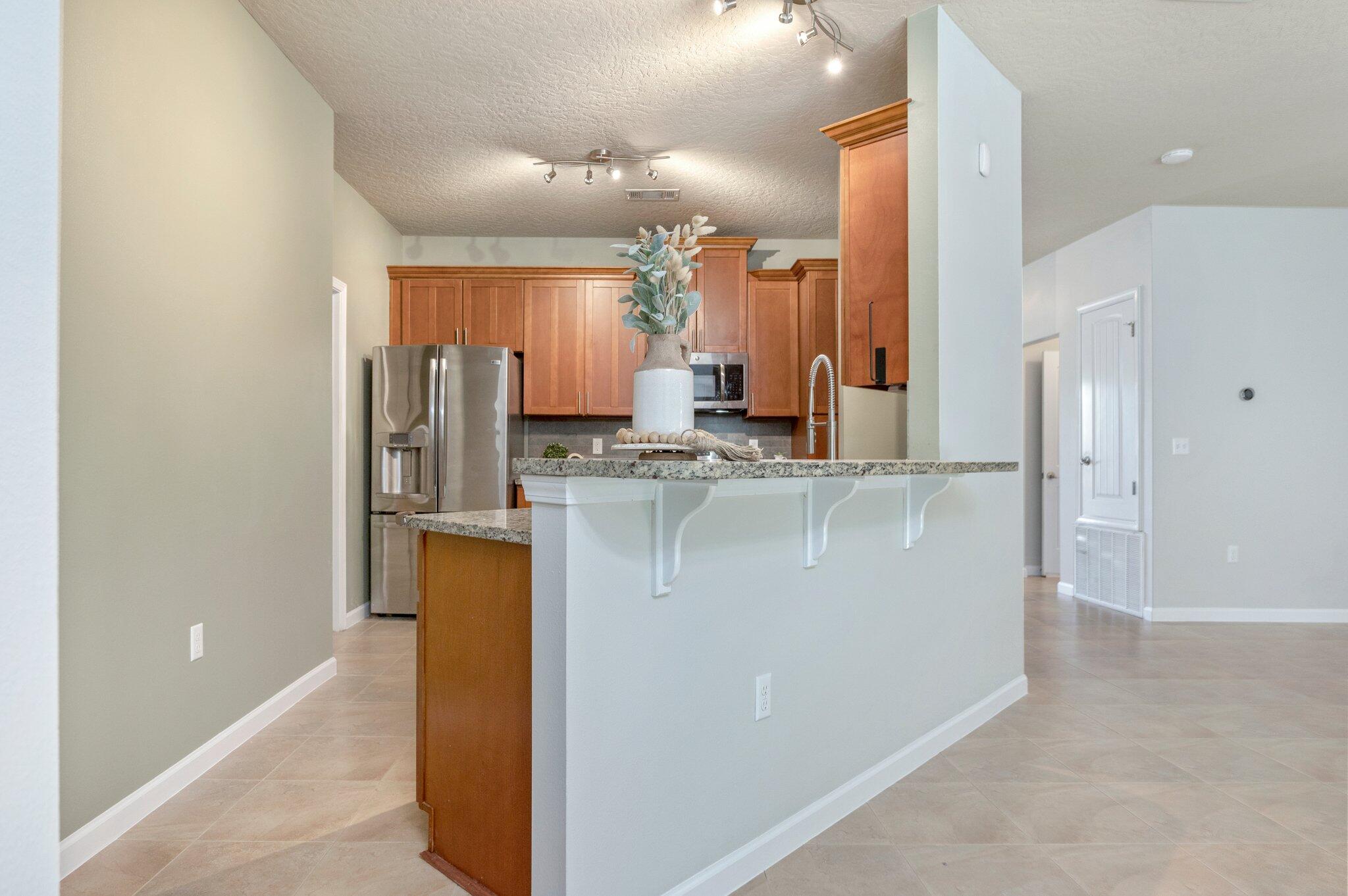5280 Moore Loop Crestview, FL 32536 - Photo 21 of 54 a view of kitchen with stainless steel appliances granite countertop cabinets and a counter top space