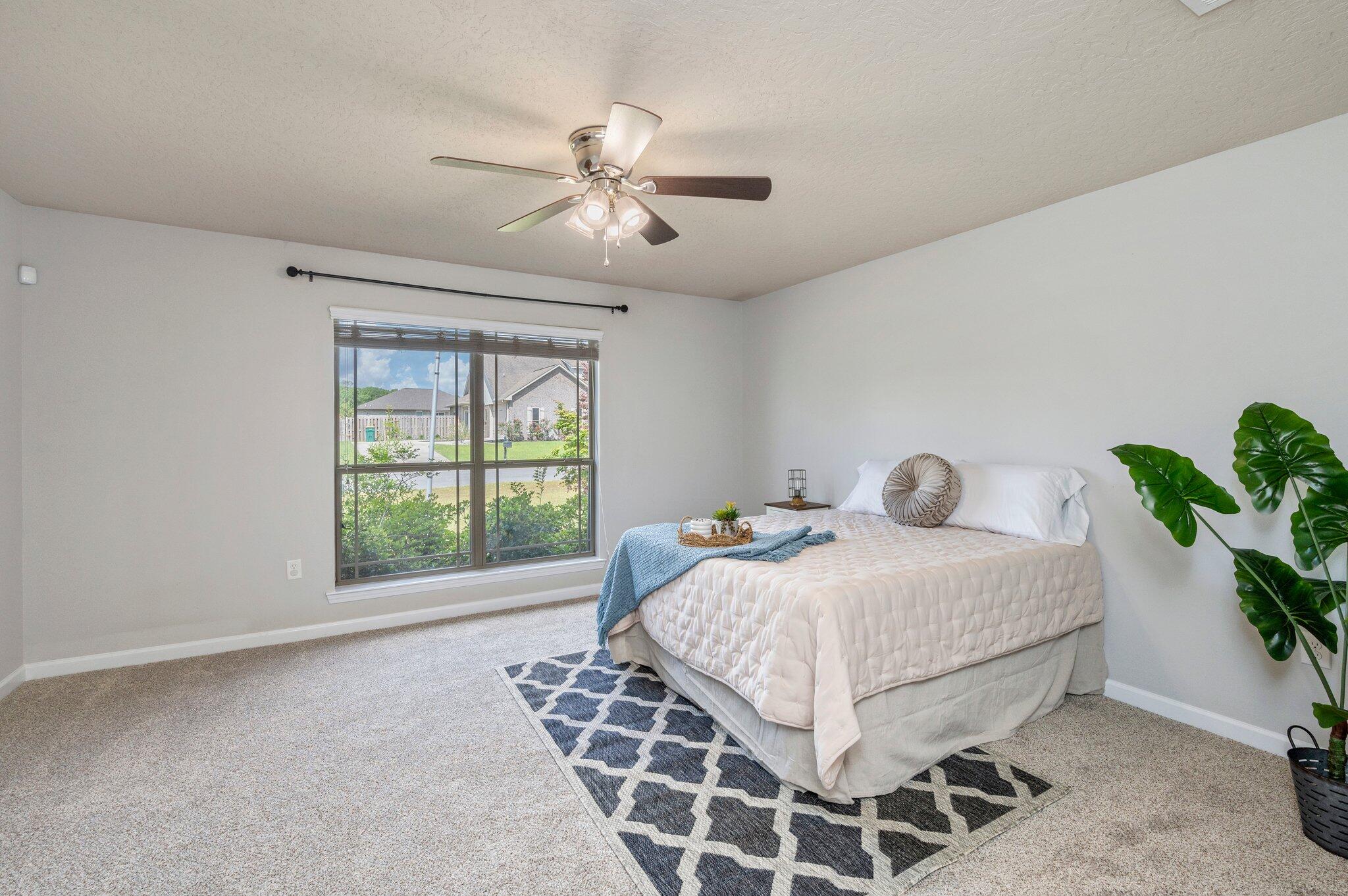 5280 Moore Loop Crestview, FL 32536 - Photo 25 of 54 a bedroom with a large bed and a window