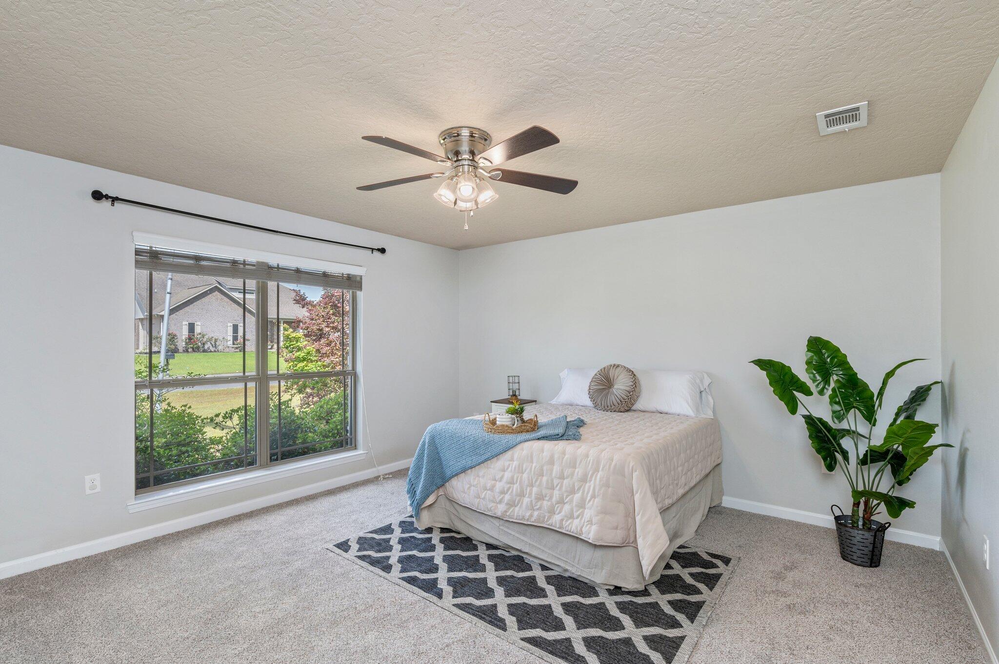 5280 Moore Loop Crestview, FL 32536 - Photo 26 of 54 a bedroom with a large bed and a window