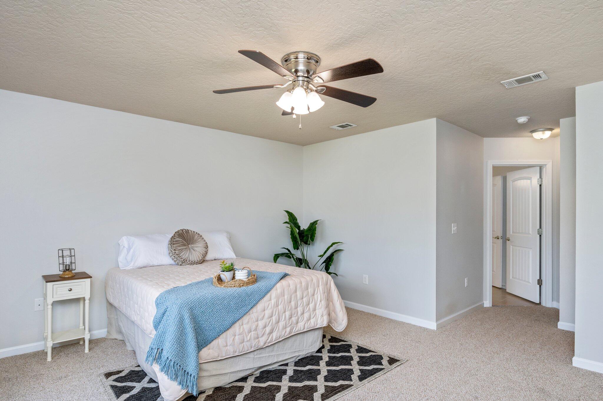 5280 Moore Loop Crestview, FL 32536 - Photo 27 of 54 a bedroom with a bed and a chandelier