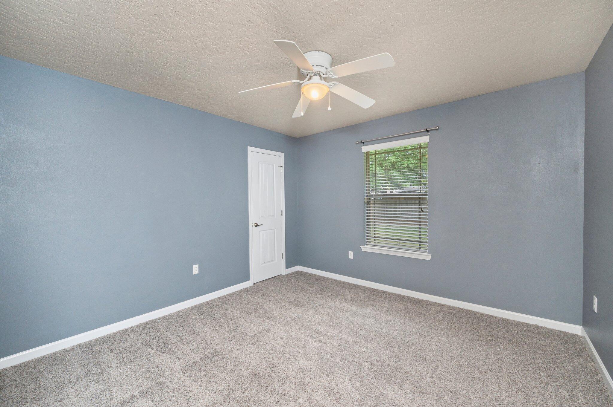 5280 Moore Loop Crestview, FL 32536 - Photo 38 of 54 an empty room with windows and fan
