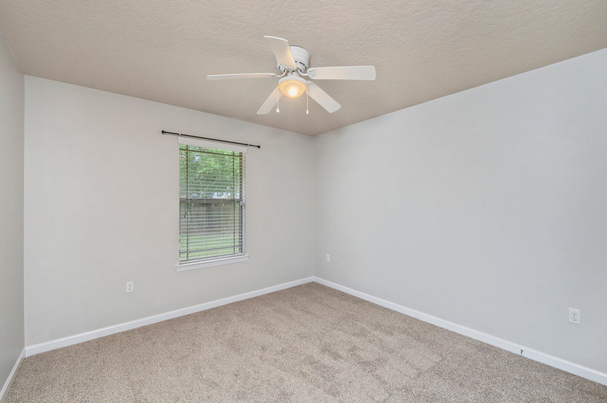 5280 Moore Loop Crestview, FL 32536 - Photo 40 of 54 an empty room with a window and a fan