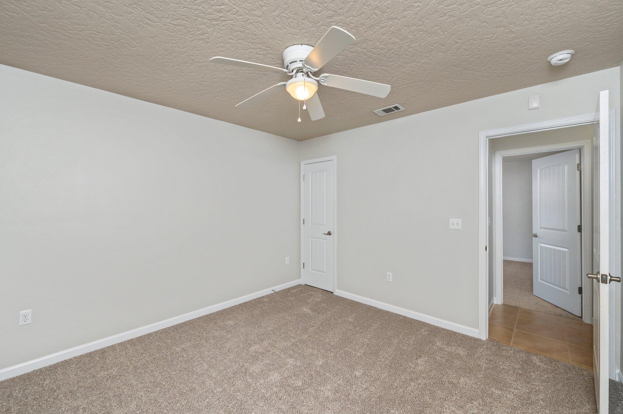 5280 Moore Loop Crestview, FL 32536 - Photo 41 of 54 a view of an empty room with a ceiling fan and a ceiling fan