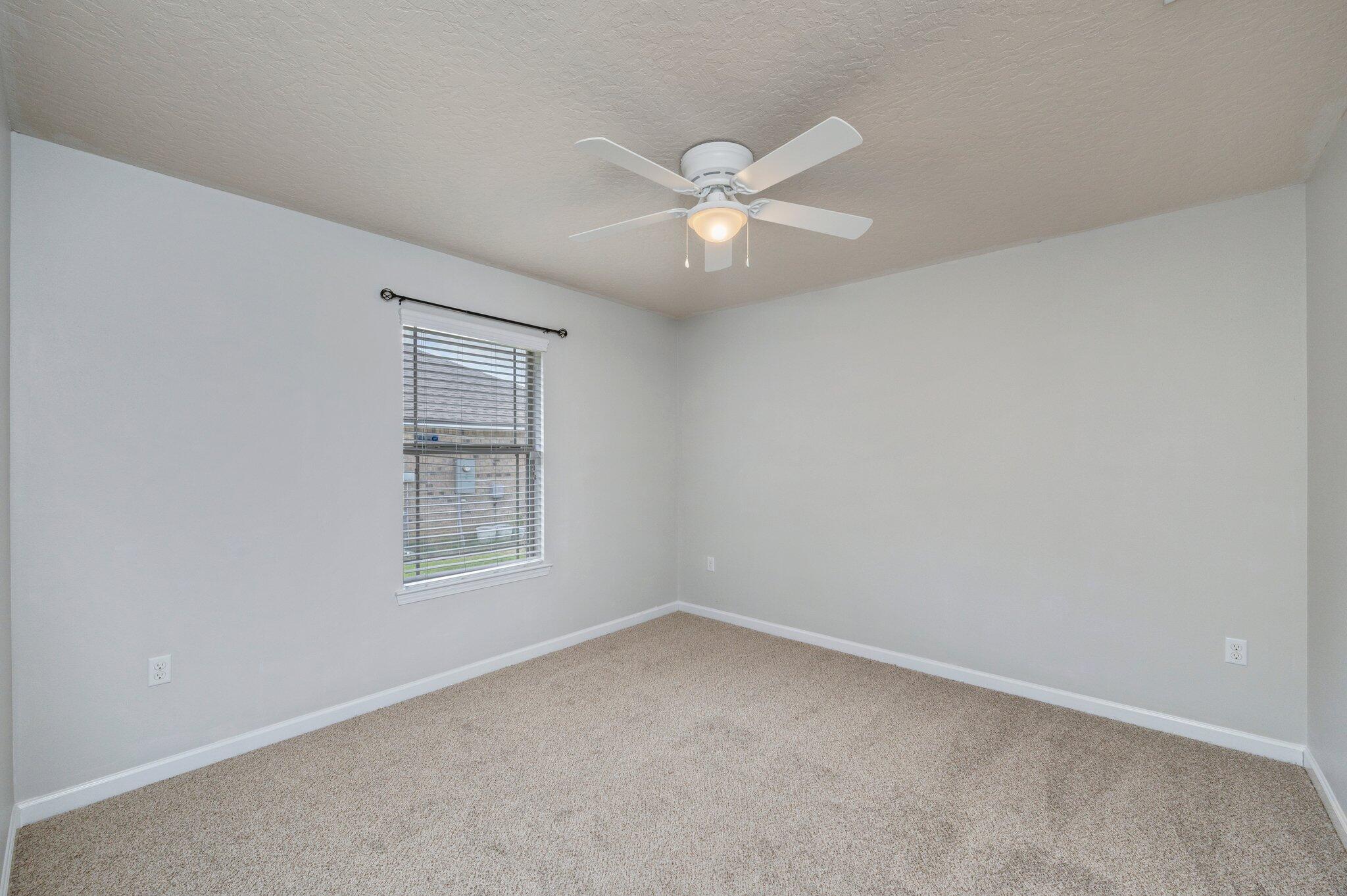 5280 Moore Loop Crestview, FL 32536 - Photo 42 of 54 an empty room with a window and ceiling fan