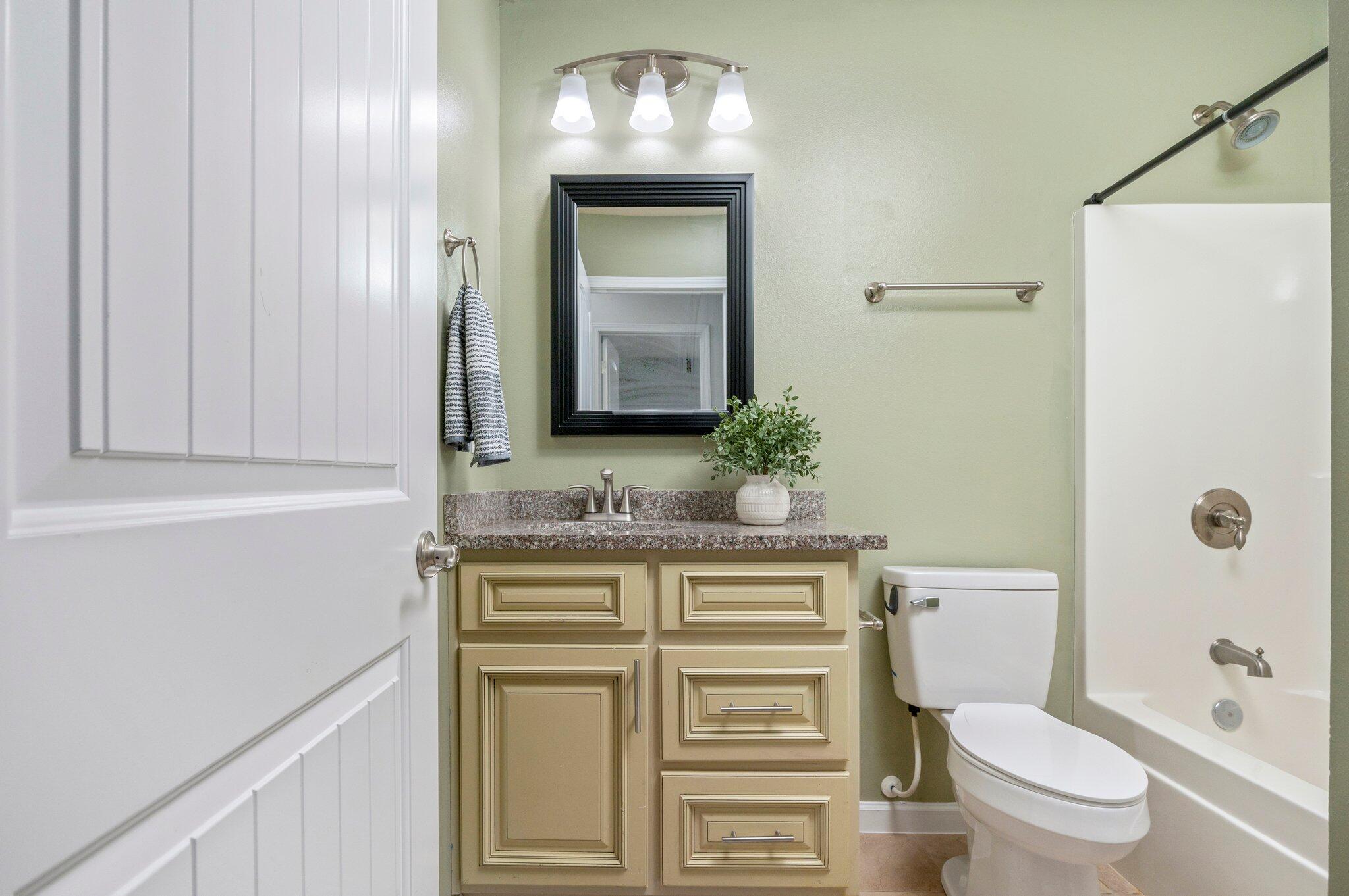 5280 Moore Loop Crestview, FL 32536 - Photo 44 of 54 a bathroom with a granite countertop toilet a sink and a mirror