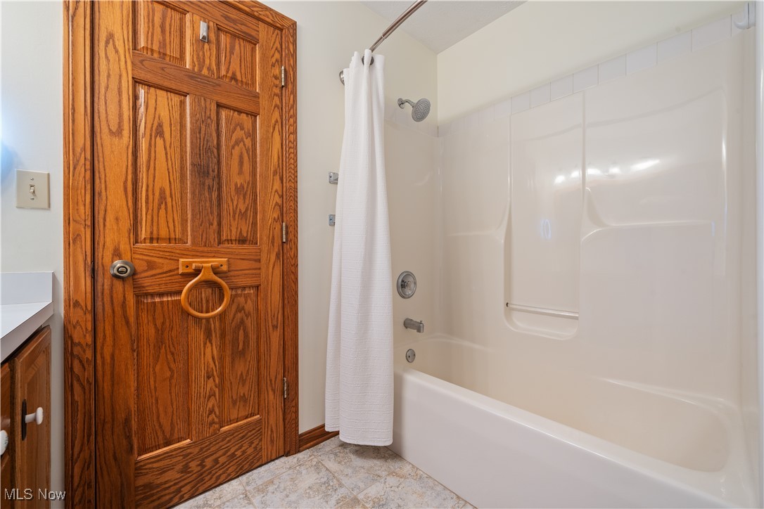 891 Station Road Valley City, OH 44280 - Photo 23 of 45 Bathroom featuring vanity and shower / bath combination with curtain