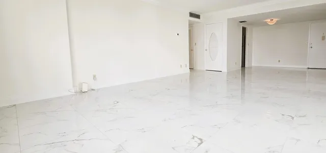 an empty room with an entrance to other room