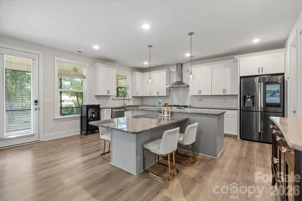 a kitchen with counter top space a sink appliances and cabinets