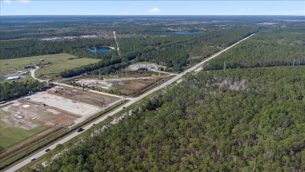a view of a yard with a wooden fence