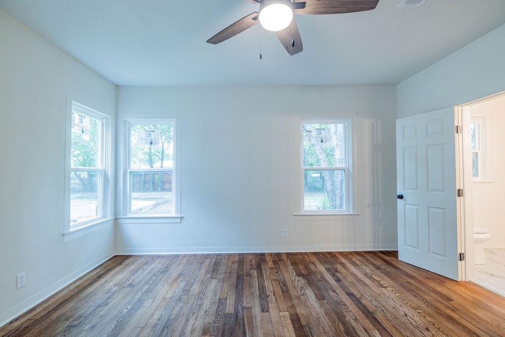 711 Fannin Street Nocona, TX 76255 - Photo 15 of 35 a view of an empty room with wooden floor and a window