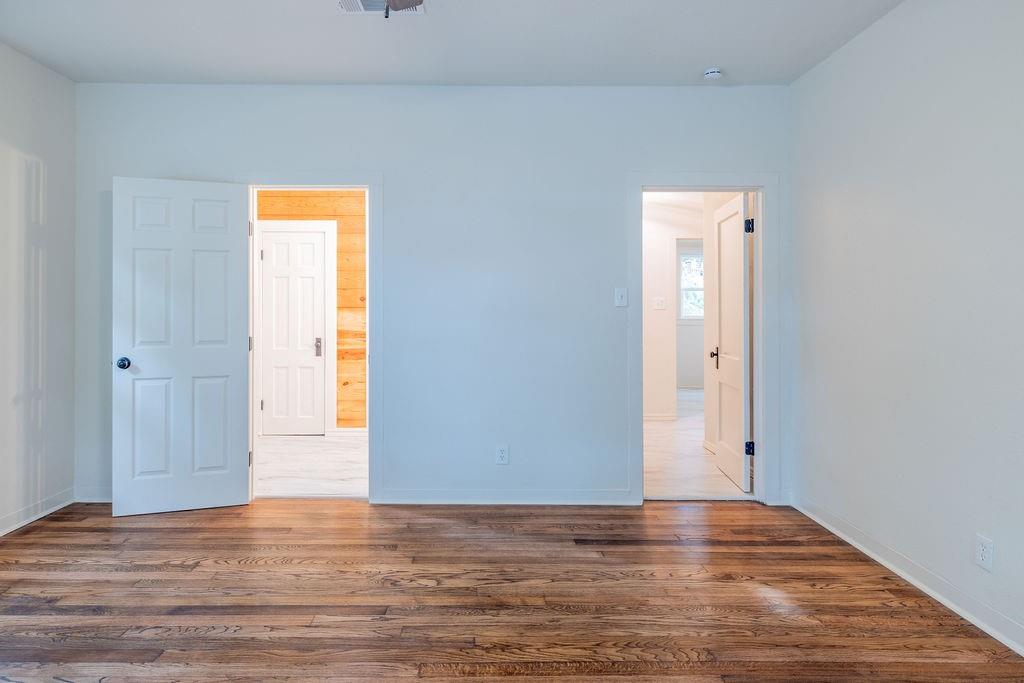 711 Fannin Street Nocona, TX 76255 - Photo 17 of 35 a view of an empty room with wooden floor and a window