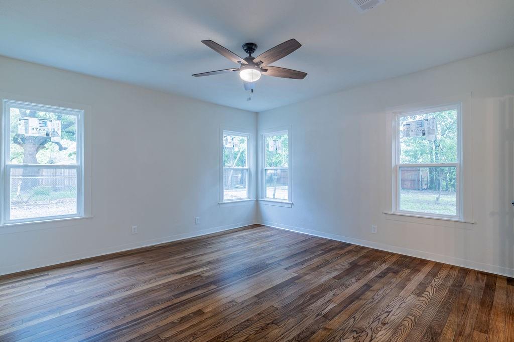 711 Fannin Street Nocona, TX 76255 - Photo 18 of 35 a view of an empty room with wooden floor and a window