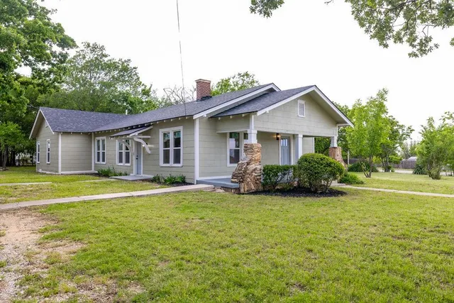 a front view of a house with a garden