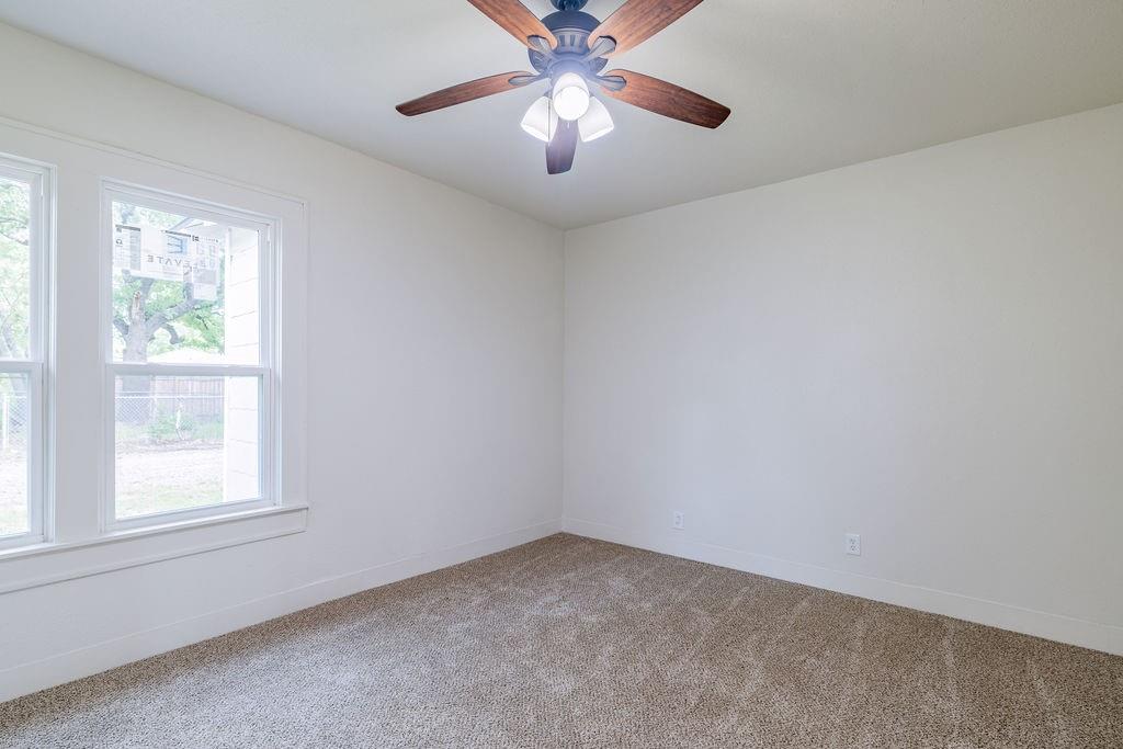 711 Fannin Street Nocona, TX 76255 - Photo 25 of 35 an empty room with a window and a fan