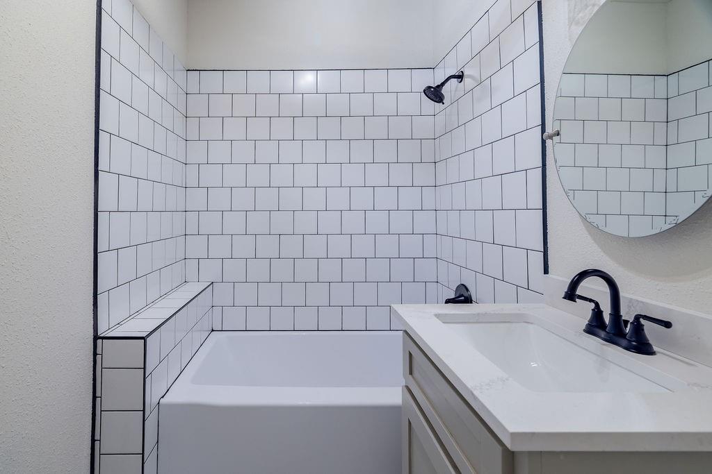 711 Fannin Street Nocona, TX 76255 - Photo 29 of 35 a bathroom with a sink and a shower